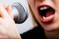 Closeup on female singer mouth and microphone