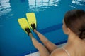 Closeup female swimmer legs wearing flippers over water surface in pool Royalty Free Stock Photo