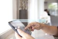 Closeup of female using her digital tablet in coffee shop cafe and restaurant for searching data internet and information