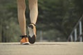 Closeup female walking with orange shoes on road in park for health concept Royalty Free Stock Photo