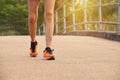 Closeup female walking with orange shoes on road in park for health concept Royalty Free Stock Photo