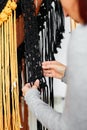 Closeup of female weaving threads and creating a macrame wall-hanging decoration