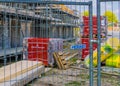 Closeup of a fence in front of a construction site with building materials and house in background, construction site in Rucphen,