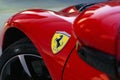 Closeup of the Ferrari SF-90 front fender badge and unfocused mirror