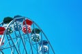 Closeup of a ferris wheel with blue sky