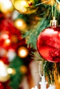 Closeup of Festively Decorated Outdoor Christmas tree with bright red balls on blurred background. Vertical shot