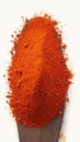 Closeup fiery red chili pepper powder on white background.