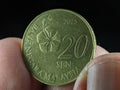 Closeup finger holding 20 cent Malaysia coin Royalty Free Stock Photo