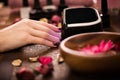 Closeup finger nail care by manicure specialist in beauty salon.