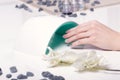 Closeup finger nail care by manicure specialist in beauty salon.