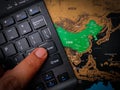 Closeup of a finger pressing "enter" on a black keyboard on top of the China map - business concept Royalty Free Stock Photo