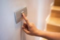 Closeup of finger is turning on or off on light switch at the house Royalty Free Stock Photo