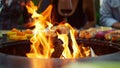 Closeup fire flames burning in bbq grill on backyard. Vegetables cooking outdoor