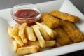 Closeup fish and chips with french fries - unhealthy food, grey backgrpound Royalty Free Stock Photo