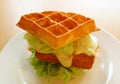 Closeup fish fillet waffle sandwich with fresh lettuce and tartar sauce