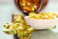 Closeup fish oil dietary supplement. Wooden spoon of oil fish capsules. Omega 3 pills fish oil capsules Royalty Free Stock Photo
