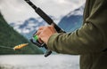 Fisherman Holding Fishing Rod with Spinning Reel Royalty Free Stock Photo