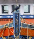 closeup of a fishing boat with a crow perching in front of it Royalty Free Stock Photo