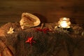 Closeup of a fishing net, candle, and seashell on a surface, a marine-themed composition Royalty Free Stock Photo