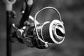 Fishing reel on a rod with a woven thread in black and white