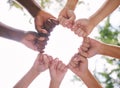 Closeup of fists in a circle outside in nature. Diverse group of peoples fists touching. Multiethnic people with their Royalty Free Stock Photo