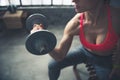 Closeup on fitness woman lifting dumbbell in loft gym Royalty Free Stock Photo