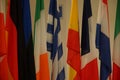 Closeup of flags of European countries inside the EU parliament building