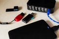 Closeup of flash drives, mobile tablet, charging cable, and multiple USB ports on the desk Royalty Free Stock Photo