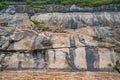 Closeup of flowing tar on rocks of shore of Yangtze River, Chongqing, China