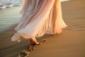 closeup of flowy dress hem as woman strolls on beach sand