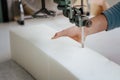 Closeup of a foam cutter machine, cutting through an upholstery foam