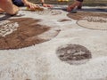 Closeup of foamy carpet of bubble soap and detergent with hands scrubbing and cleaning the carpet rug with brushes during Royalty Free Stock Photo