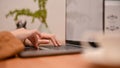 Female typing on keyboard, searching something on the website via laptop computer Royalty Free Stock Photo