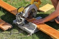 Closeup focus shot of a worker cutting lumber with a circular saw Royalty Free Stock Photo