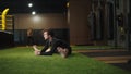 Focused fit man doing splits at gym. Male boxer making stretching in sport club Royalty Free Stock Photo