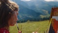 Young woman painting scenery mountains close up. Girl drawing picture on easel. Royalty Free Stock Photo