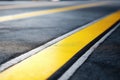 Closeup Focuses On Asphalt With Yellow Double Line Markings