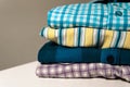 Closeup of folded flannel and striped shirts on the table Royalty Free Stock Photo