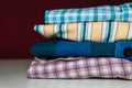 Closeup of folded flannel and striped shirts on the table Royalty Free Stock Photo