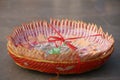 Closeup of folded rupees in a basket with a bow under the lights during an Indian wedding Royalty Free Stock Photo
