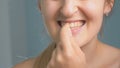 Closeup footage of young woman winkles out piece of food stuck in teeth