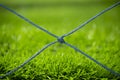 Closeup football field netting with green artificial grass background