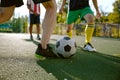 Closeup football player playing ball during training match on field