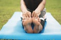 closeup foots of a young woman practicing yoga