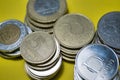 Closeup Hungarian Forint FT HUF coins stacked up in a pile laying on yellow background