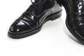 Closeup of Formal Male Stylish Black Polished Oxford Leather Laced Shoes Placed Together Over White