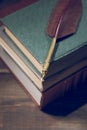 Closeup of fountain feather pen on stack of old books Royalty Free Stock Photo