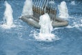 Closeup of fountain nozzles with water sprays and splashes. Aqua geysers in pool of waterworks Royalty Free Stock Photo