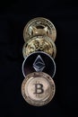 Closeup of four crypto coins in the vertical black background