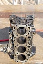 Closeup of a four cylinder engine block for repair in workshop Royalty Free Stock Photo